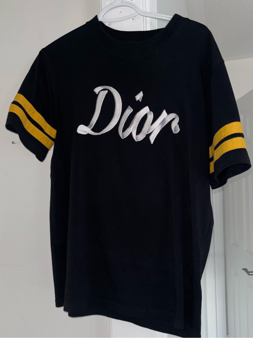 Dior Black Tee with White Script and Yellow Sleeve Stripes